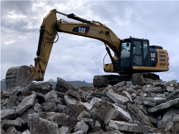 digger on mound of concrete